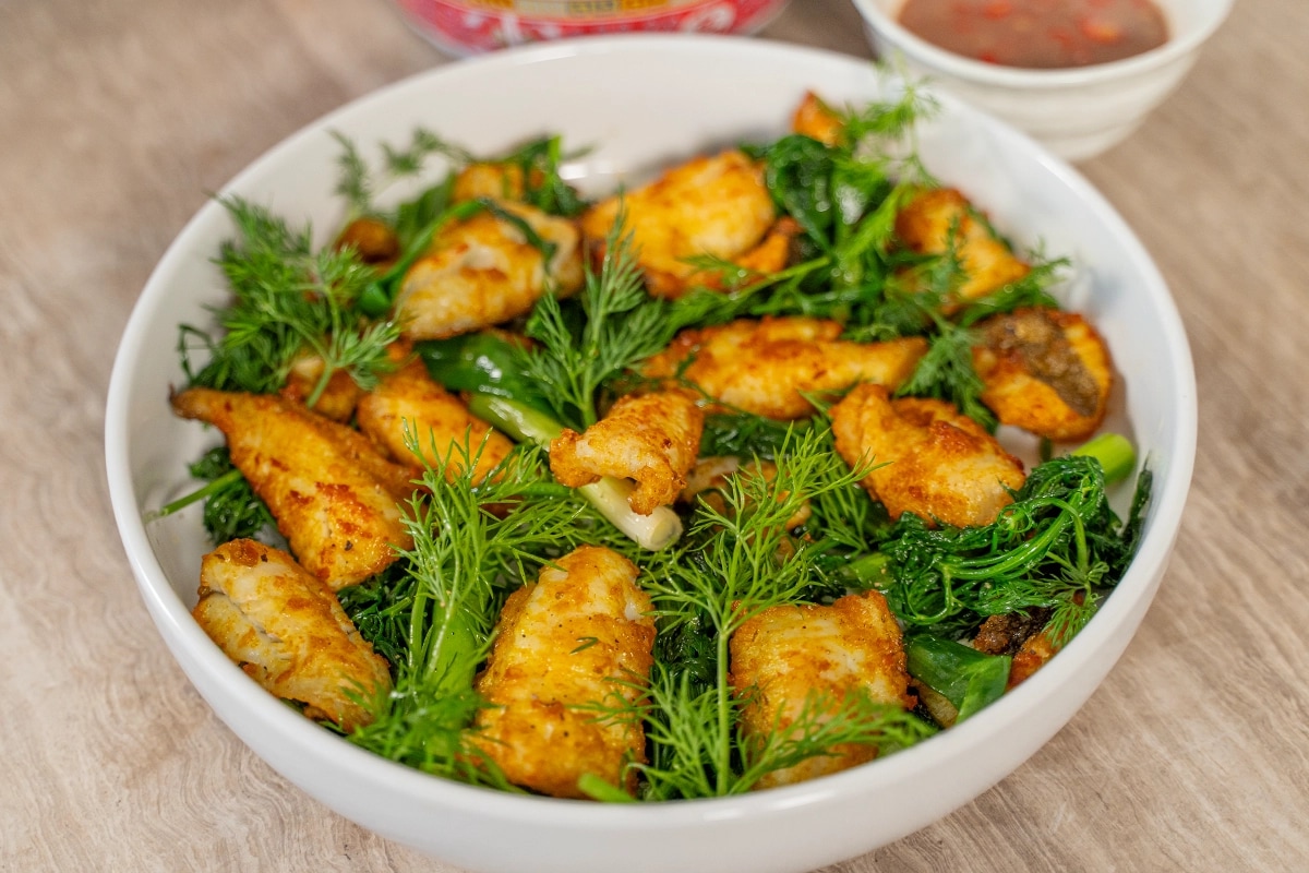 Cha Ca is a famous Hanoi dish featuring grilled turmeric-marinated fish with fresh dill
